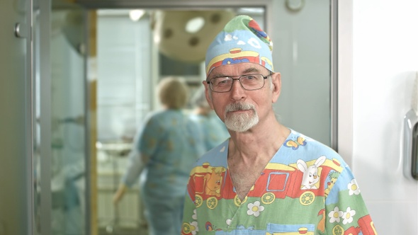 Smiling senior doctor looking at the camera in hospital