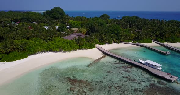 Natural birds eye copy space shot of a white sandy paradise beach and aqua turquoise water backgroun