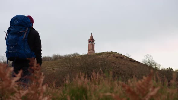 Tourist with Backpack Enjoys the View of the Top of Himmelbjerget Hill Denmark