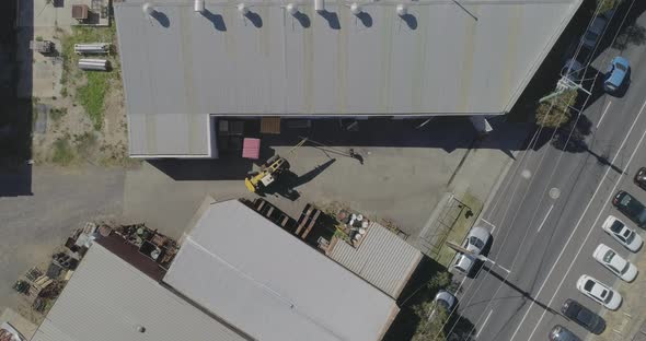 Factory worker assisting mobile crane while moving heavy beam too difficult to get the correct angle