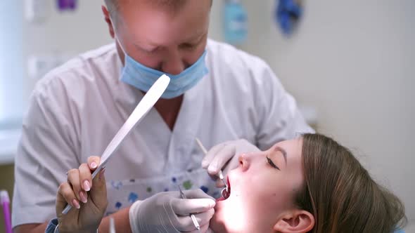 Doctor treats patient teeth in modern dental clinic. Health teeth concept. 