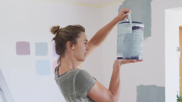 Portrait of a Caucasian woman in quarantine during coronavirus pandemic, doing interior work