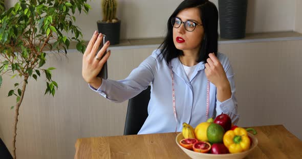 Nutritionist, dietitian woman recording on a smart phone her vlog about healthy eating