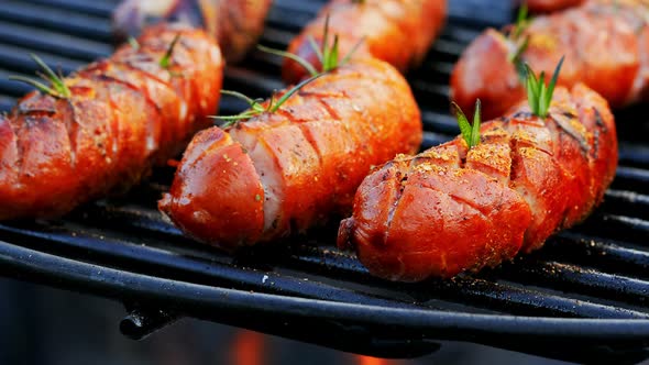 Delicious and spicy sausage on grill with spices and herbs