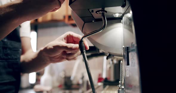 Barista at Work Making a Cup of Strong Coffee in a Modern Coffee Machine