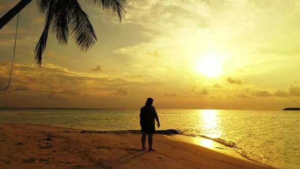 Lady tans on beautiful lagoon beach trip by blue sea with white sand background of the Maldives afte