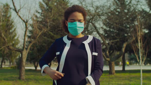 African Woman Dressing Surgical Mask During Epidemic