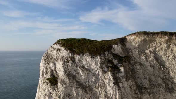 Drone flying over white cliffs of Old Harry Rocks on Purbeck island in Dorset. Aerial forward