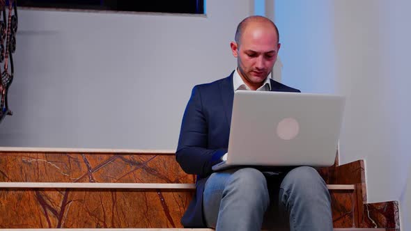 Businessman Working on Business Deadline Using Laptop