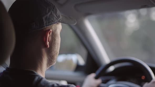 Middleaged Man Driving a Car