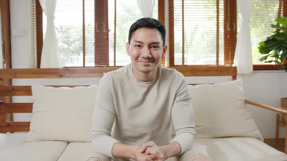 Happy young freelance asia man looking at camera smiling and cheerful relax.