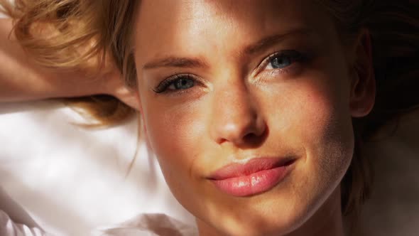 Blonde Female Gazing into Camera with Sun Shining Gently on Her Face