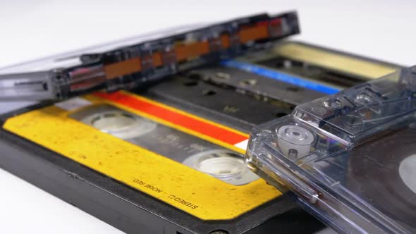 Four Audio Cassettes Rotate on White Background