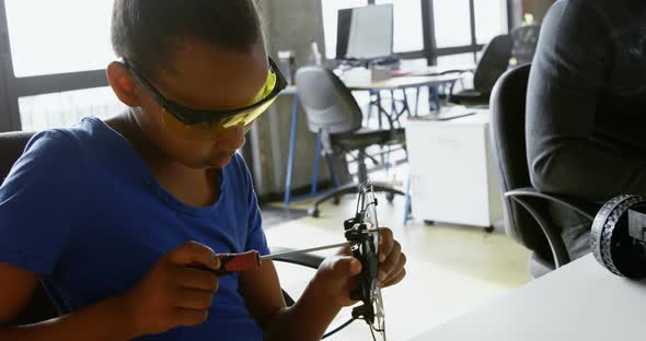 Girl repairing a drone at desk 4k
