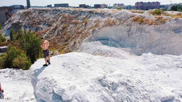 Professional bodybuilder posing outdoors.