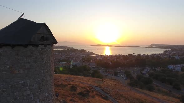 Old Traditional Historic Stone Windmill by the Sea at the Sunset