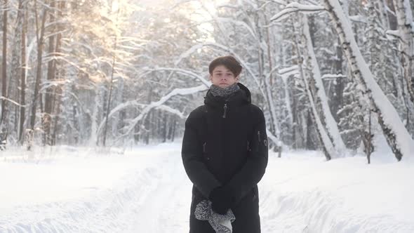 Portrait of  teenager in winter snow forest