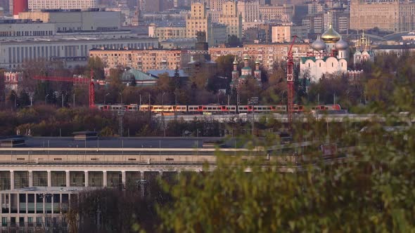 Modern Electric Passenger Train Moving in the Center of Moscow in Late Autumn