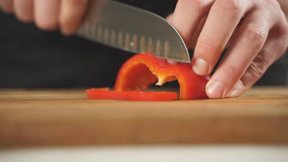 Closeup of Slicing Red Peppers on a Chopping Board