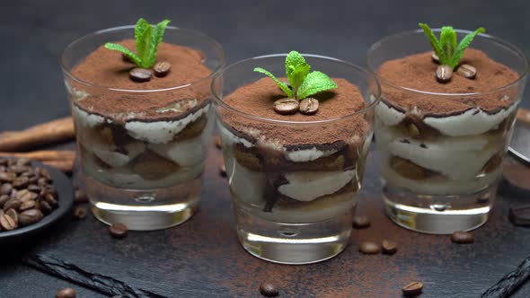 Classic Tiramisu Dessert in A Glass on Stone Serving Board on Dark Concrete Background