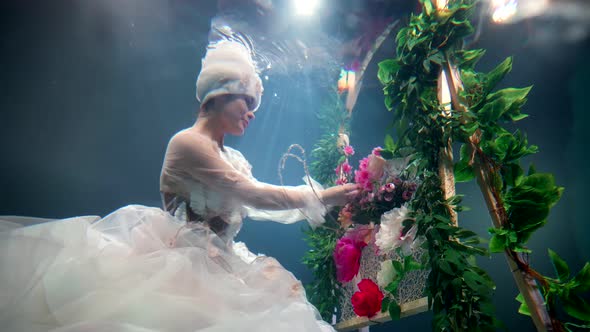 Fabulous Underwater Garden Fairytale Floral Queen is Sewing Flowers to Fence Flowing Water in Depth