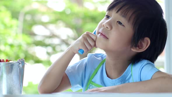 Cute Asian Child Drawing With Crayons On White Table