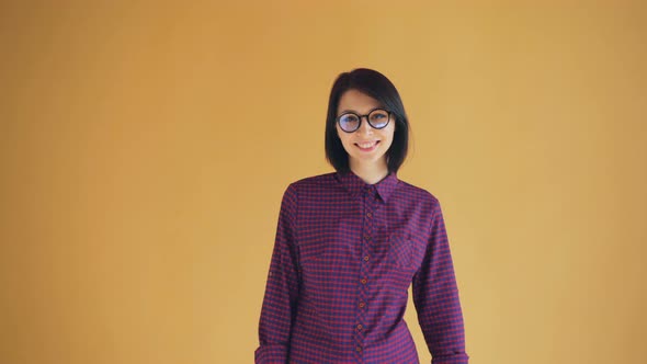 Portrait of Cute Brunette Turning To Camera and Smiling Looking at Camera