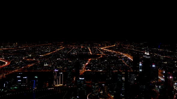 Dubai Downtown View from Skyscraper at Night with Car Traffic Moving on Roads in Time Lapse