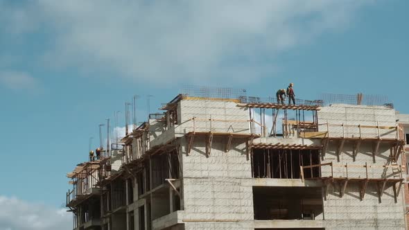Builders work on monolithic works at the construction site of a multi-storey building in Montenegro