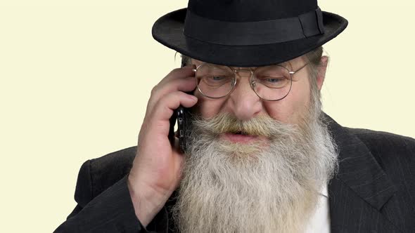 Old Bearded Man Talking on Cell Phone