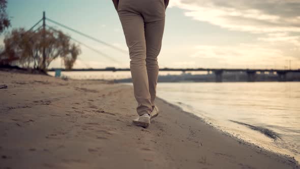 Man Feet Walking On Beach.Businessman Legs Walking River Beach.Man Legs In Shoes Walking On Sand.