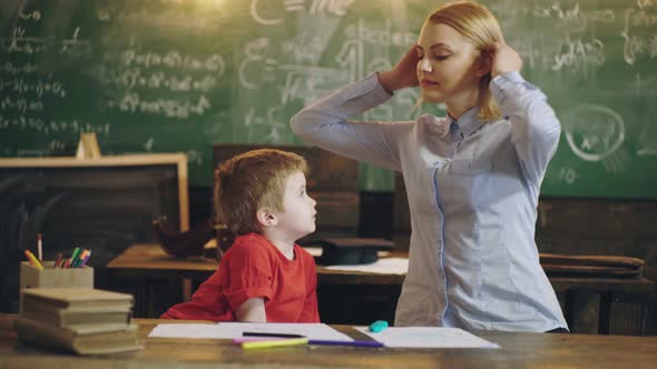 Elementary School. Teacher and Pupil in Classroom with Backbord Background, Back To School and