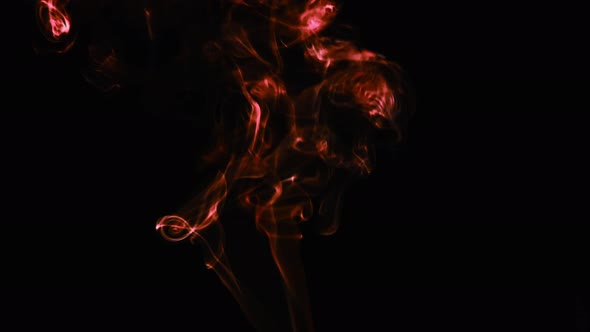 Realistic cloud smoke with streamline pattern. Abstract red smoke on dark background in slow motion.