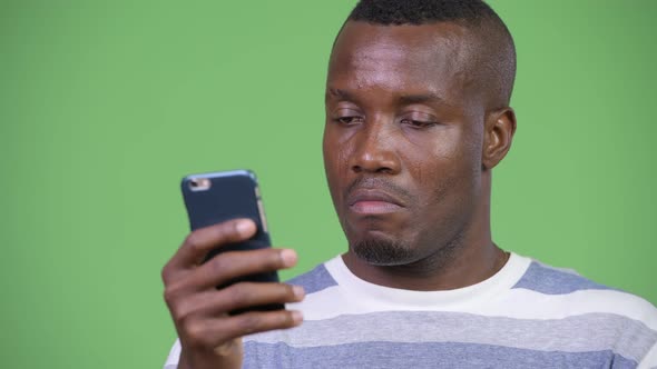 Young Happy African Man Smiling While Using Phone