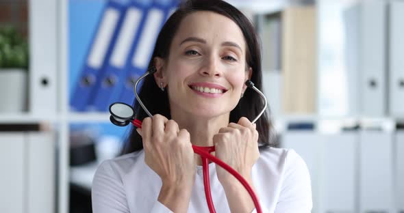 Woman Doctor Inserting Stethoscope Into Her Ears in Clinic  Movie Slow Motion