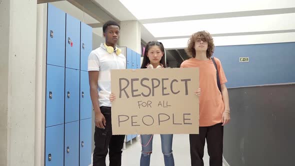 Multiethnic Group of Students Carrying a Banner on Which is Written the Phrase Respect for All