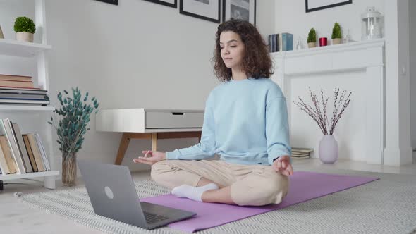 Happy Fit Young Woman Using Laptop Watching Online Yoga Lesson at Home