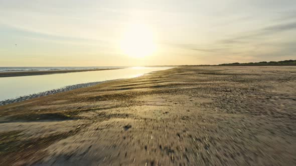 Panoramic Shot of the Beautiful Ocean Horizon By the Beach and Sun Peeking in the Sky