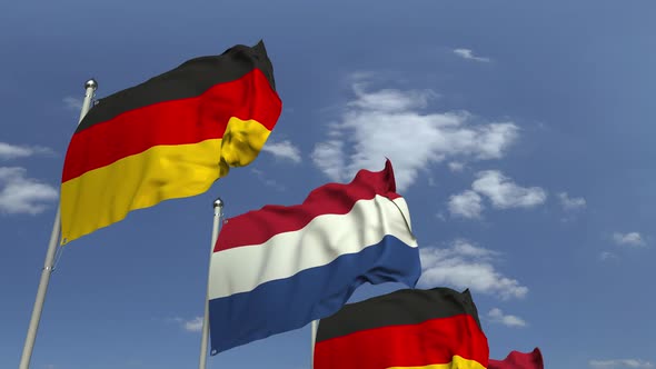 Flags of Netherlands and Germany Against Blue Sky