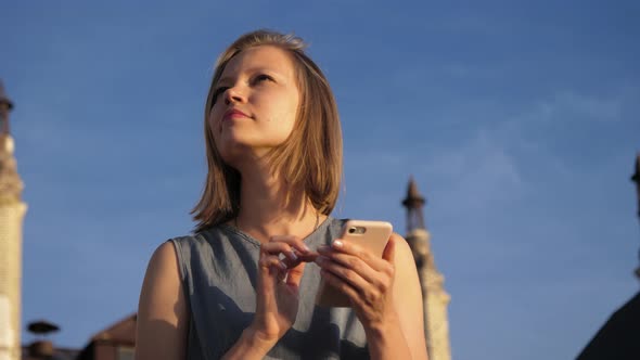 Pretty Young Woman Texts on Her Mobile Phone