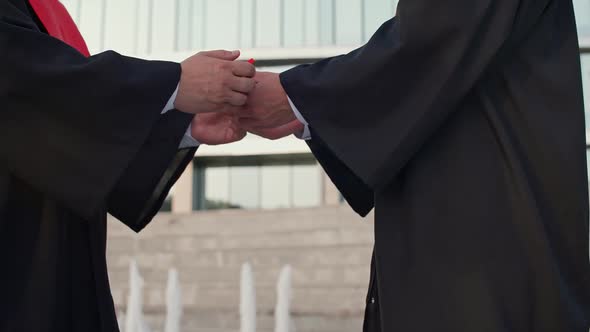 Handshake on a Graduation Ceremony Senior Lecturer Presents a Diploma to a University Graduate a