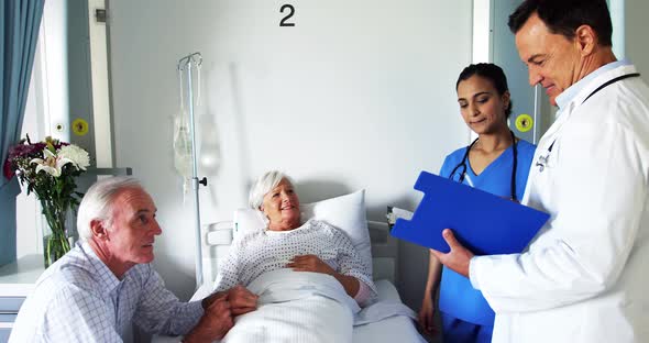 Doctor discussing report with senior couple