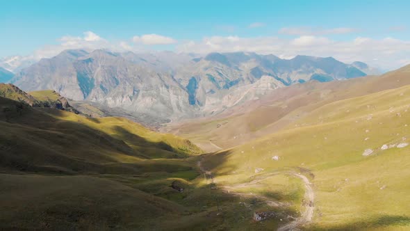 Beautiful Valley Landscape with a Bird's Eye View on the Background of Mountains, Road in a Mountain