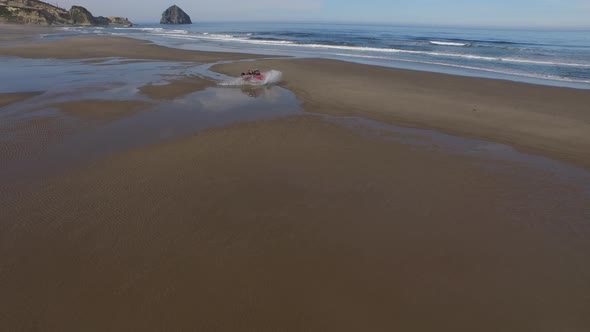 Aerial shot of 4x4 off road vehicle driving on beach