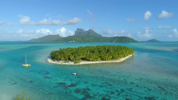 Aerial drone view of a deserted island near Bora Bora tropical island.