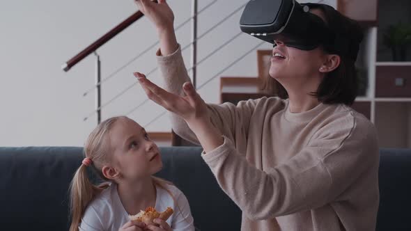 Female Sitting Near Her Daughter and Using Virtual Reality Glass