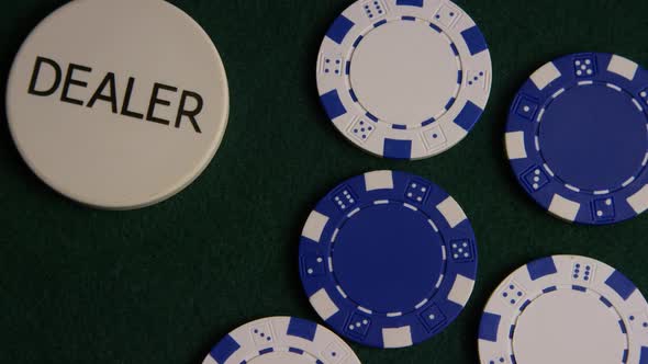 Rotating shot of poker cards and poker chips on a green felt surface - POKER 038