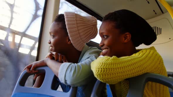 Twin sisters looking through window in the bus 4k