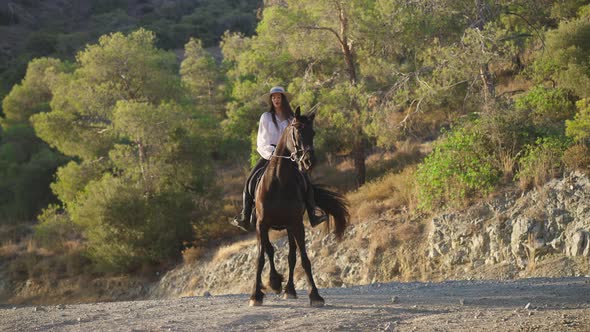 Front View of Graceful Horse Making Steps Beating Hoof Moving Aside with Female Equestrian on Back