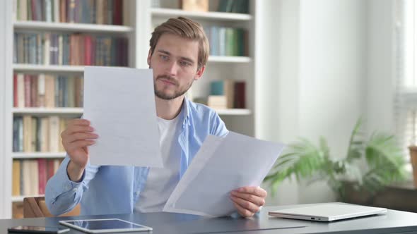 Man Reading Documents in Office